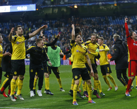 Dortmund holds Madrid 2-2 to win group, break scoring record