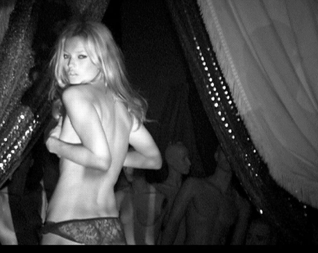 Kate Moss poses topless