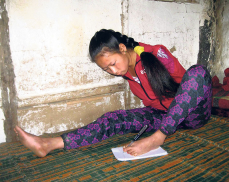 Handicapped girl writes her exams with foot