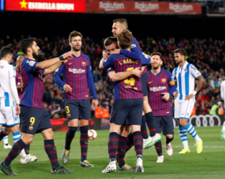 Barca put one hand on title after edging past Sociedad
