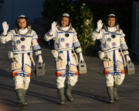 China launches first three-man crew to new space station