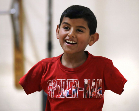 Armless Syrian boy thrives in US, hopes family can join him