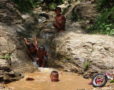 Kids romp around in rain-fed rivulet (photo feature)