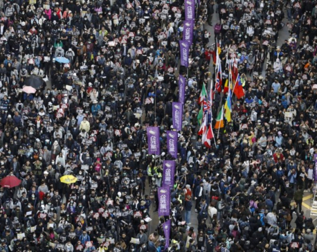 Thousands march as Hong Kong protests near half-year mark