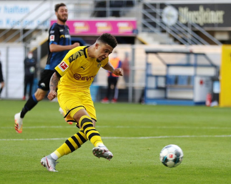 Sancho hat-trick keeps Dortmund in title hunt