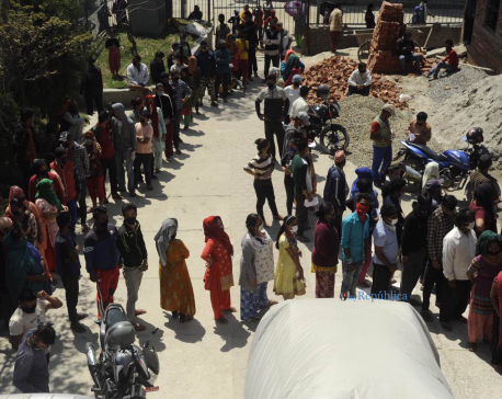 Amid lockdown order, people queuing up for govt relief without maintaining social distancing (with photos)