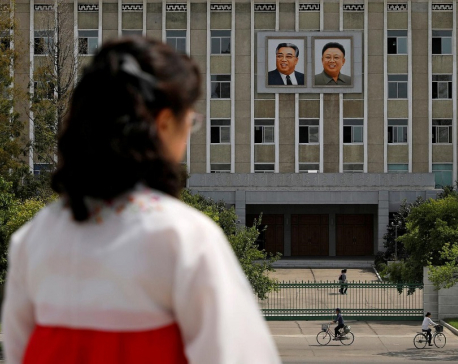 N.Korea calls for tougher virus curbs, but leader wears no mask in photographs