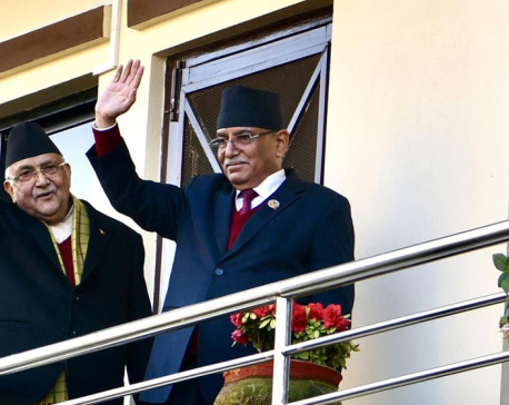 After agreeing to form a new government, Oli and Dahal greet supporters from balcony