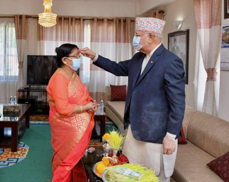 PM Oli offers Dashain 'tika' and 'jamara' to spouse Radhika Shakya