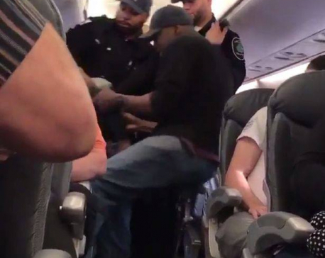 United Airlines under fire after passenger dragged from plane; officer put on leave