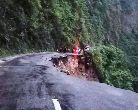 Car and motorcycle fall off the landslide-hit road