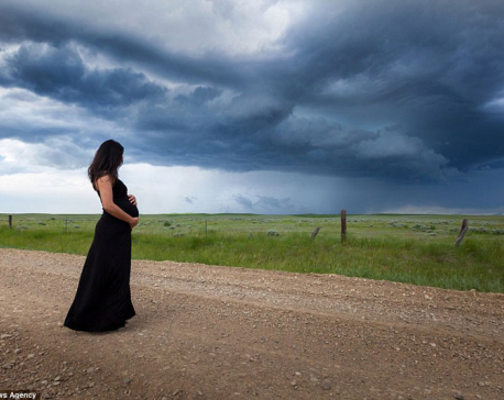 Mother-to-be poses in the middle of dramatic storms