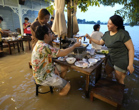 At flooded restaurant near Bangkok, the special is a splash