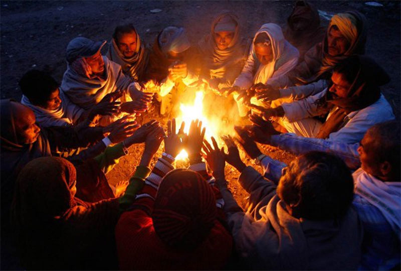 People huddle around fire as cold grips Tarai