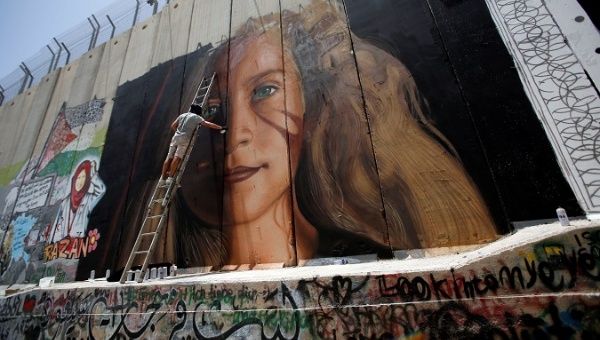 New mural of Palestinian Ahed Tamimi painted on "Occupation Wall"