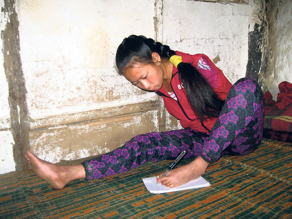 Handicapped girl writes her exams with foot