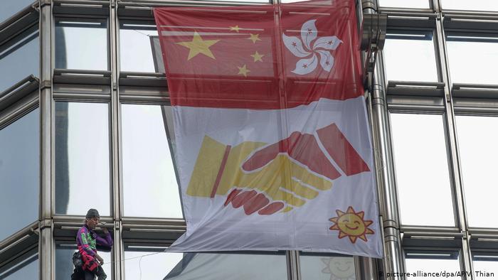 French 'spiderman' climbs HK tower, hoists reconciliation flag amid mass protests
