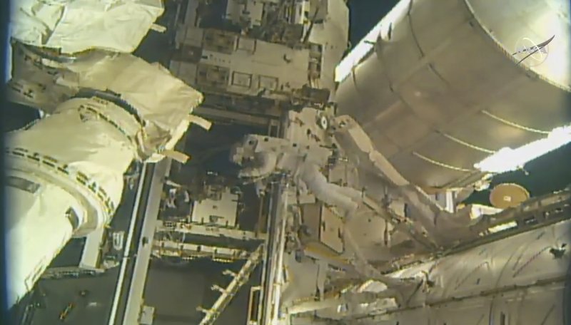 Spacewalking astronauts add parking spot to space station