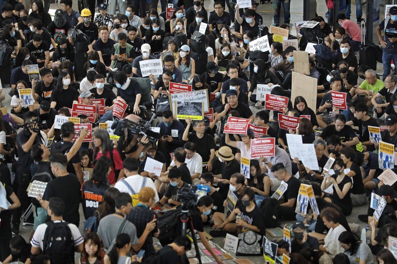 Thousands defy police ban, march in Hong Kong district