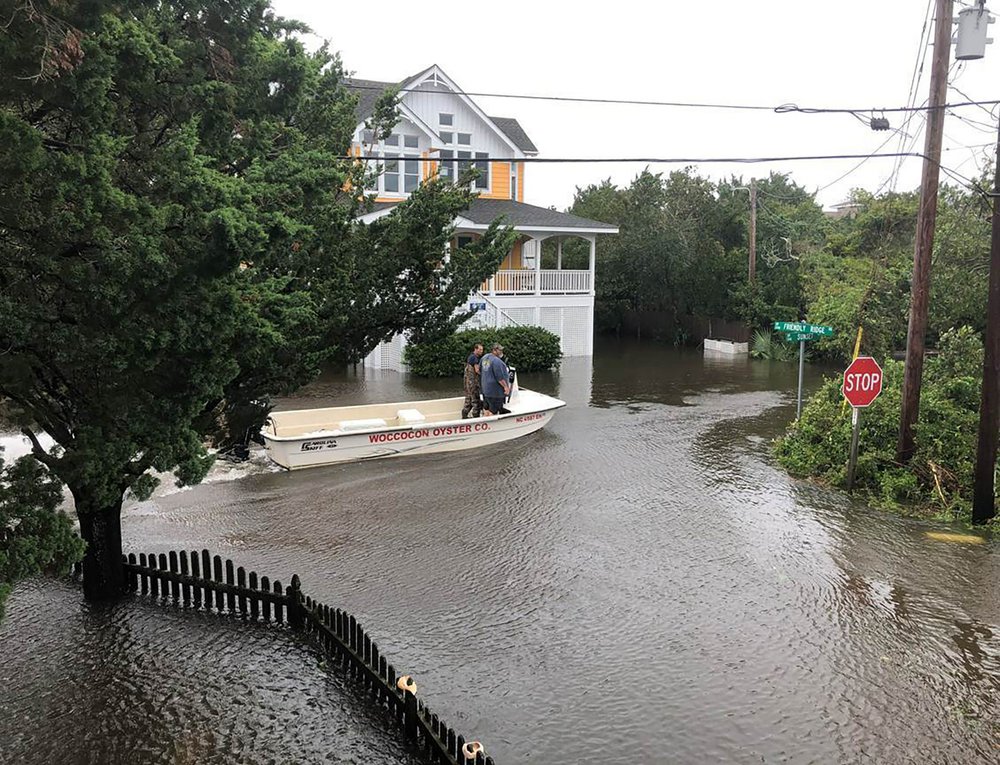 Dorian’s floodwaters trap people in attics in North Carolina