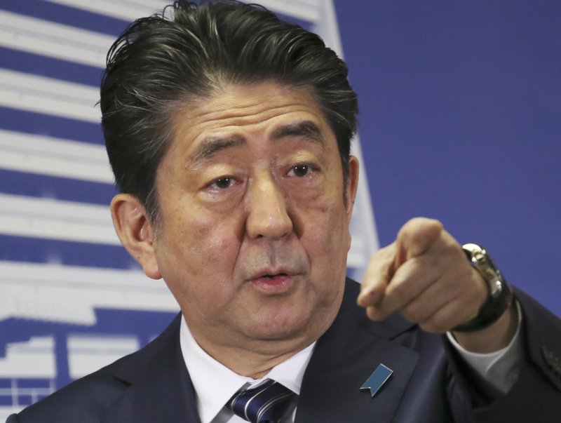 The Latest: Exit polls show Abe’s ruling bloc wins elections