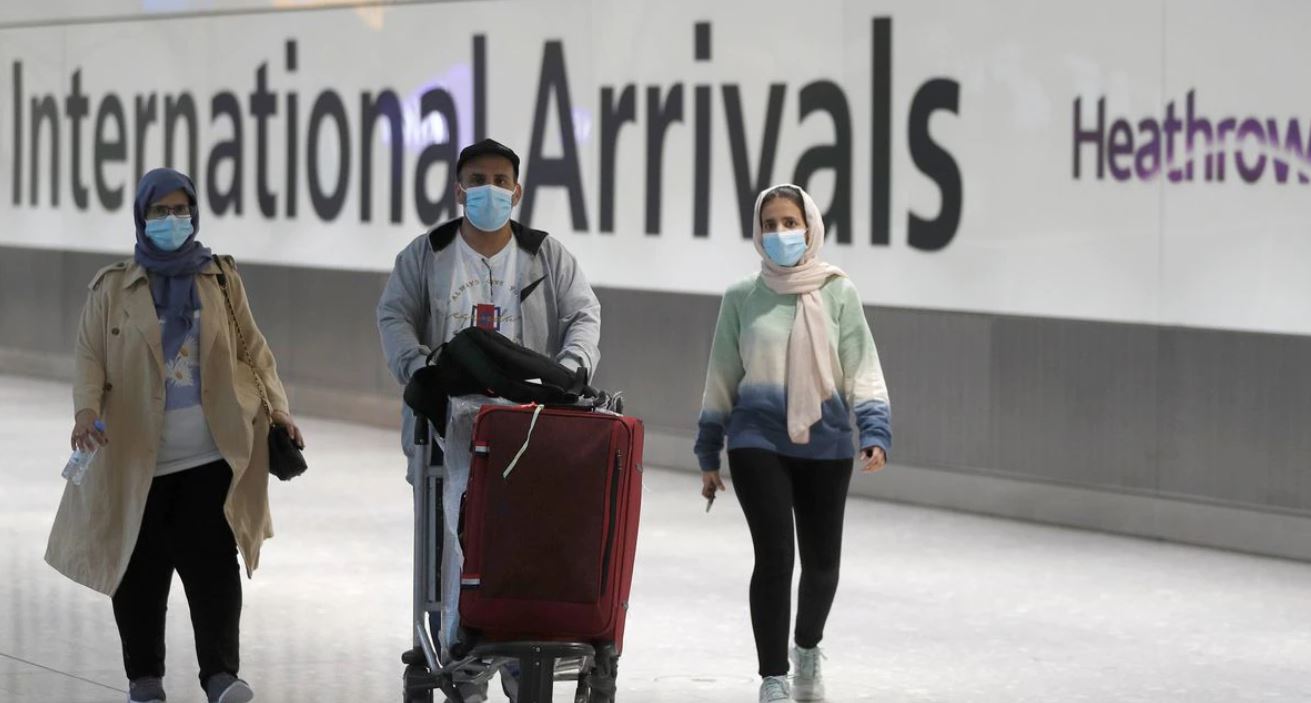 WHO urges travelers to wear masks as new COVID variant spreads