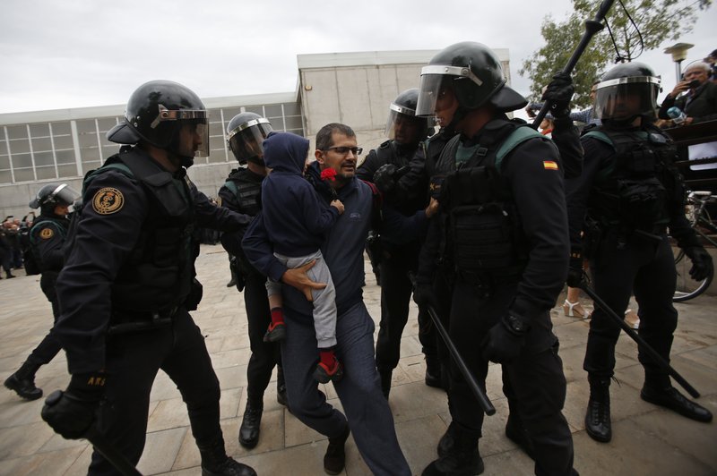 Spain riot police smash way into Catalan voting center