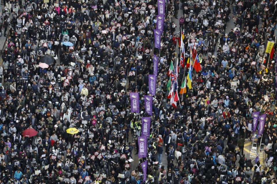 Thousands march as Hong Kong protests near half-year mark