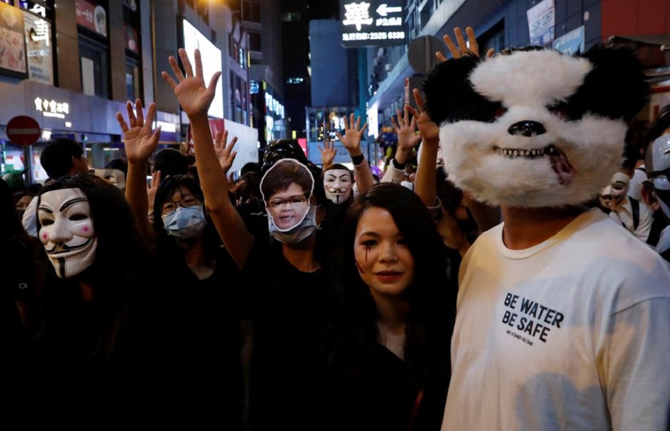 HK police fire tear gas in Kowloon as protesters across harbour gatecrash Halloween