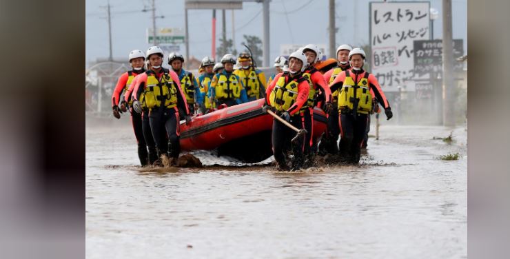 Japan rescuers wade in muddy waters to find typhoon survivors