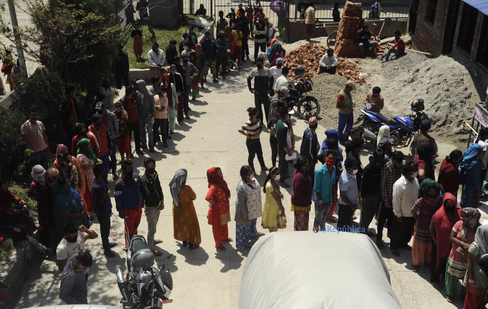 Amid lockdown order, people queuing up for govt relief without maintaining social distancing (with photos)