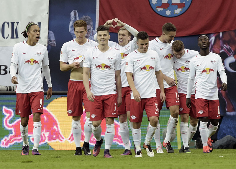 Promoted Leipzig brushes off critics to go top of the table