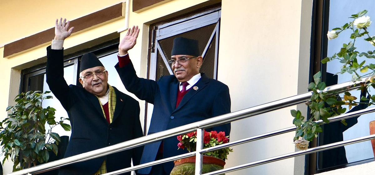 After agreeing to form a new government, Oli and Dahal greet supporters from balcony