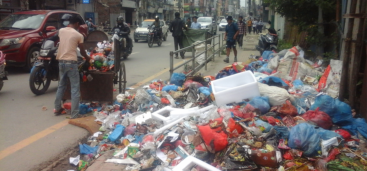 Company responsible for waste management piles up garbage on sidewalk at Putalisadak
