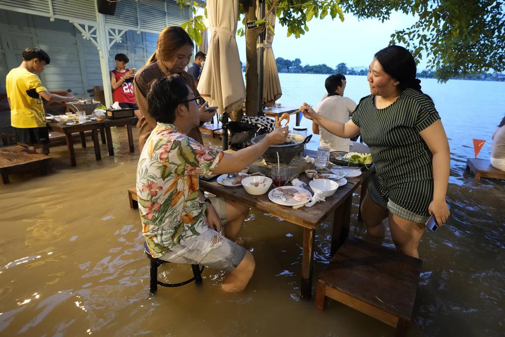 At flooded restaurant near Bangkok, the special is a splash